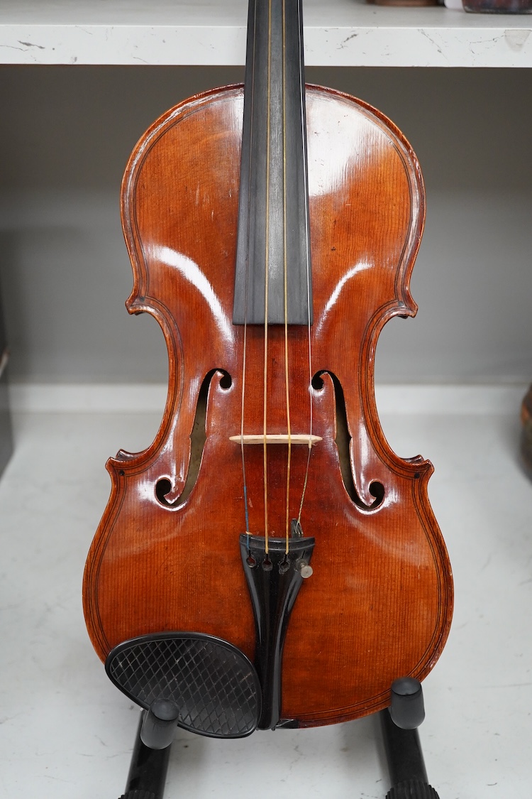 A late 19th century German violin after Pablo Maggini in bird’s eye maple with a fully mounted German bow in a crocodile skin case with retailers ivorine label reading; ‘Edward Withers, 22 Wardour Street, phone City 1899